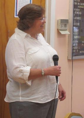 Kim McDaniel, Schoolhouse Center Director, welcomes attendees to dinner on the final night of the Caregiver Academy. 
