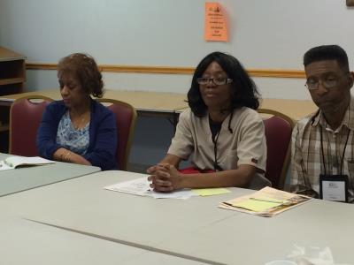 Caregivers Diane Thompson, and Crystal and Antonio Townes listen as presenter, Sharon White, discusses teamwork and asking for help. 