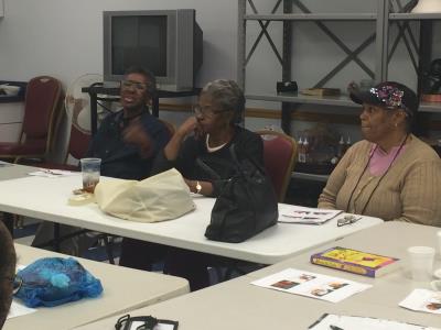 Caregivers Judy Purcell, Grace Brown-Johnson, and Vanessa Sanders listen to presenter, Tom Carroll.