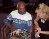 Bhanu Vaghela holds a hairless guinea pig while Caring Paws program aide, Terry Napoli, looks on.