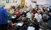 Coach Cheryl Macklin PhD leads Compassion and Self Care group in heart breathing exercises.
