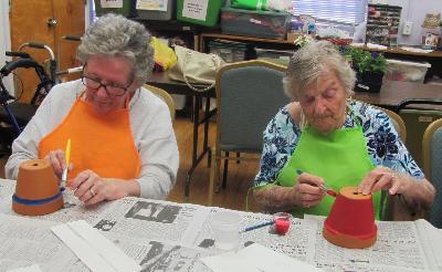Care receivers participate in a horticulture activity.