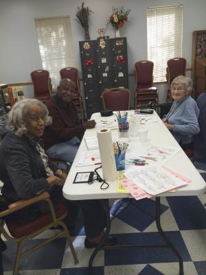 Care receivers Gloria Thompson, Matthew Purnell, and Penny Marinakis ready to work on their Creative Arts projects. 