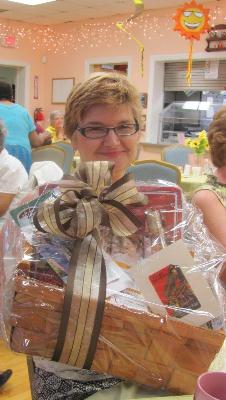 Raffle winner displays her prize at the dinner on the final night of the Caregiver Academy. 