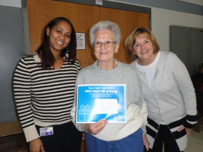 Christy Bobo (left), Housing Director at COSA, raffle winner Jeane Brower (center), of Brookhaven, and Joana Geiger (right) Link coordinator. 