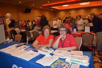 Marie Bonita (right), Community Outreach Coordinator, COSA and a volunteer COSA ambassador share information on COSA's programs and services.