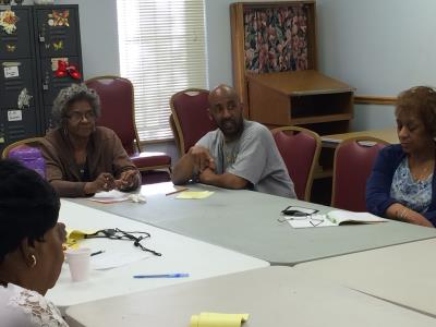 Caregivers Grace Brown-Johnson, Truluck Christopher Legette, and Diane Thompson listen to presenter, Sharon White.