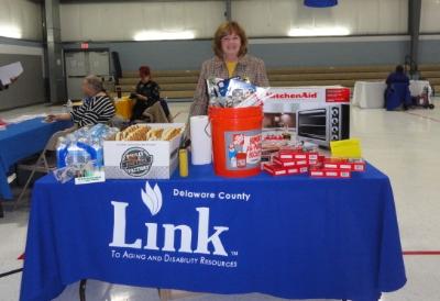 Joanna Geiger, ADRC Coordinator, displays some of the raffle prizes at the Energy Fair.  The Delaware County Link to Aging and Disability Resource Center sponsored the Energy Fair.