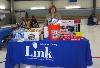 Joanna Geiger, ADRC Coordinator, displays some of the raffle prizes at the Energy Fair.  The Delaware County Link to Aging and Disability Resource Center sponsored the Energy Fair.