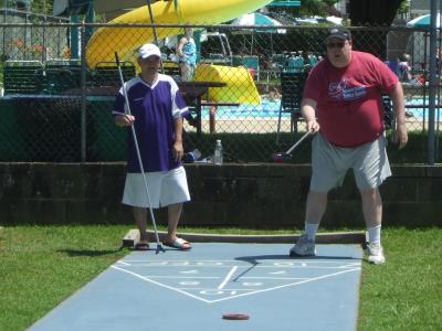 John Dang and Ray Young Jr. compete in Shuffleboard