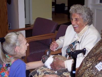 Director, Marjorie Shoemaker, introduces a rabbit named Fenwick to Eleanor Miller.