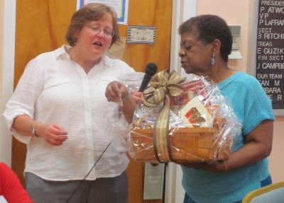 Kim McDaniel, Director of Schoolhouse Center, chooses a raffle winner at the dinner on the final night of the Caregiver Academy. 