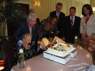 Delaware County Council Vice Chair, Mario J. Civera, Jr. helps Marion Roth, 104, and Nancy Fisher, 108 cut the centenarian birthday cake.